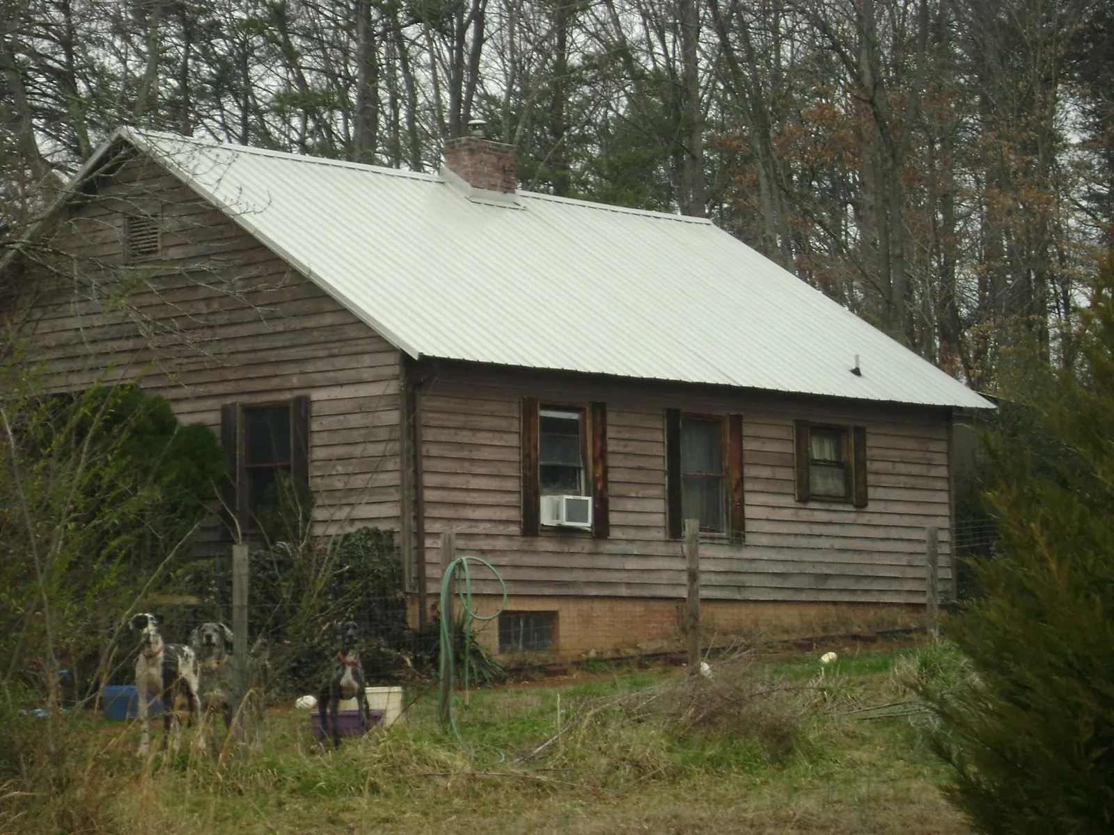 White metal roof on an old wood sided farmhouse, from a Asphalt Shingle Roof Repair job in Baxley